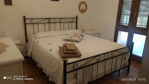 a bedroom with a bed with a towel on it at Case vacanze Corrado 2 in La Capriola