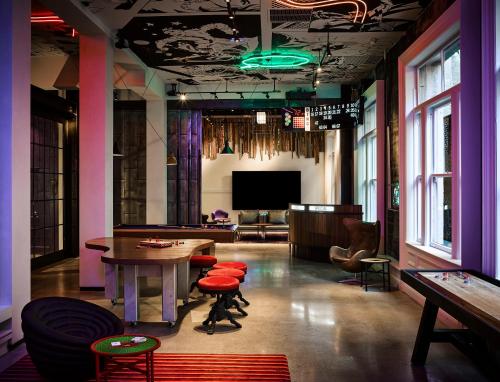 a room with a table and chairs and a tv at Hotel Zeppelin San Francisco in San Francisco