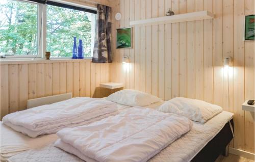 a large bed in a room with a window at 3 Bedroom Nice Home In Esbjerg V in Esbjerg