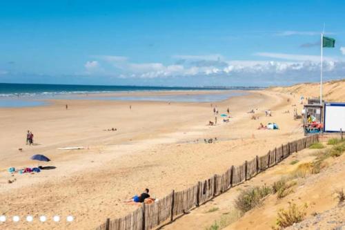 un groupe de personnes sur une plage près de l'océan dans l'établissement Bright house with garden in Sables-d'Olonne, à Les Sables-dʼOlonne