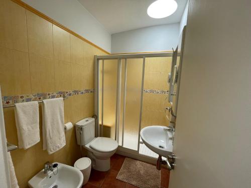 a bathroom with a toilet and a sink and a shower at Deluxe Las Marinas Beach in Maspalomas