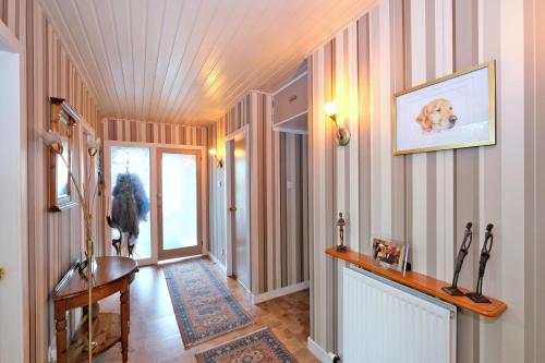 a hallway of a home with a dog on the wall at The Jays Guest House in Aberdeen