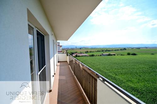 a balcony with a view of a green field at FLH - Unique Vibes Residence Magnolia Sibiu in Sibiu