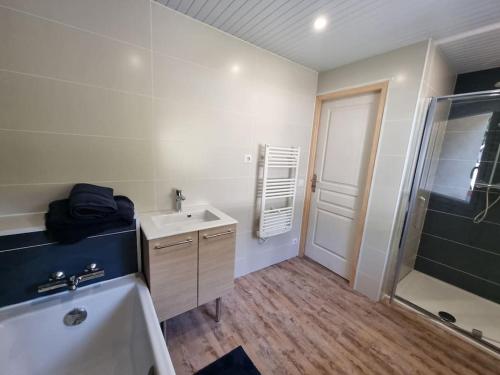 een badkamer met een bad, een wastafel en een douche bij MAMGOZ in Clohars-Carnoët