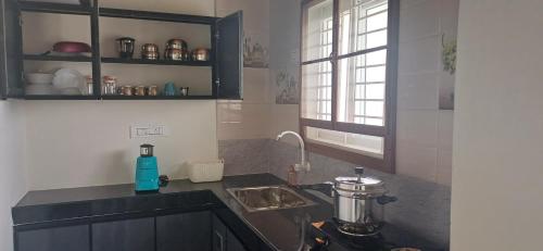 a kitchen with a sink and a counter top at SHI's Peaceful Oasis near Isha Adiyogi, Kovai Kuttralam Waterfalls & Karunya University in Alāndurai