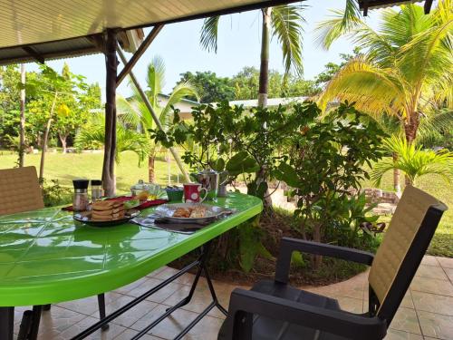 a green table with food on it on a patio at BeautyByNature Estate by "Khadija&Family", unique private rooms, homemade dishes in a wonderful setting in Wa