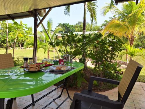 a green table with food on it on a patio at BeautyByNature scenery, room with TOP AC, private bath, restaurant in Wa