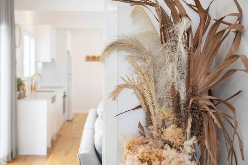 a plant in a vase sitting on a couch at Blissful Merewether Beach Cottage - A Coastal Gem in Newcastle