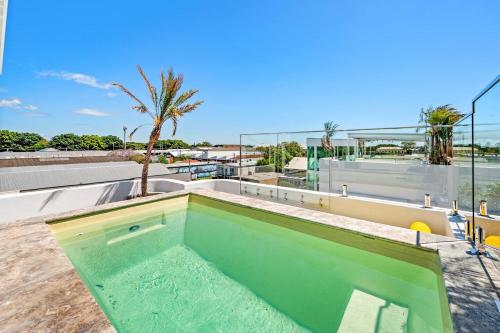 a swimming pool on the roof of a house at 'Harbour Lights' Iconic Maritime-inspired Living in Wickham