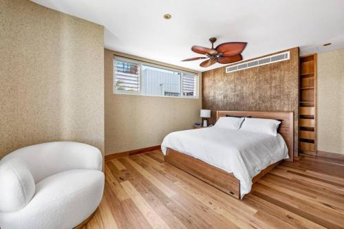 a bedroom with a bed and a ceiling fan at The Urban Resort - A Mediterranean-style Group Haven across Two Homes in Wickham