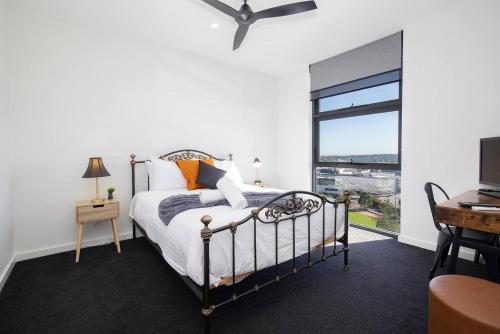 a bedroom with a bed and a large window at 'Highpoint Lookout' A Cool Charlestown Square Abode in Charlestown