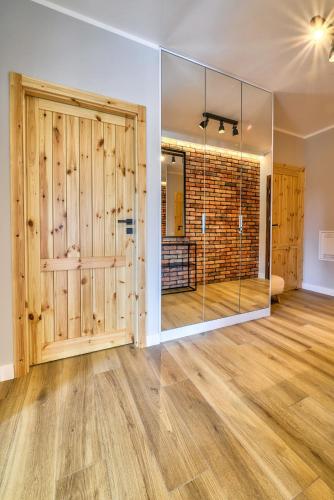 a room with a glass door and a brick wall at Nautica Resort in Giżycko