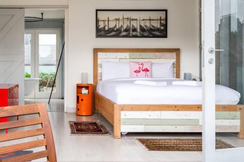 a bedroom with a bed with a wooden frame at Urban Farmhouse Flair - Surry Hills Terrace Serenity in Sydney
