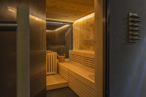 a sauna with wooden walls and wooden floors at Das Graseck - mountain hideaway & health care in Garmisch-Partenkirchen