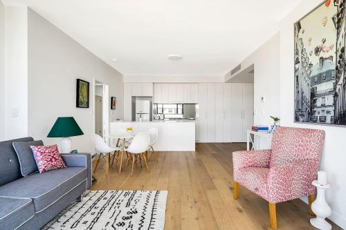 a living room with a couch and a table at Bright Rockdale Escape near Bayside Beaches in Sydney