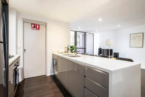 a kitchen with a white counter and a sink at 'The Patio' Live like a Local in Spacious Comfort in Sydney