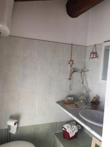 a bathroom with a toilet and a sink at Il mondo magico - Immerso nella natura - in Fauglia