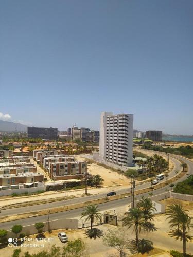 an aerial view of a city with a tall building at Margarita & More, Omas in Porlamar