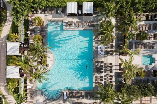 an overhead view of a swimming pool with palm trees at Gorgeous Partial Ocean View I The Ritz Carlton in Miami