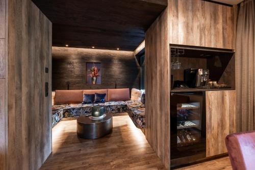 a living room with a couch and a table at Luxury Apart Sailers including Premium Summercard in Sankt Anton am Arlberg