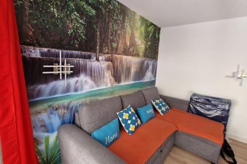 a couch in a room with a painting on the wall at WOW* mer/piscine/climat/parking in Cannes