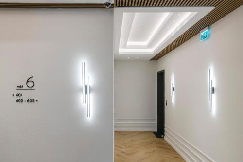 a room with white walls and a skylight at The Forest - Luxe Central Apt with free secured parking in Braşov