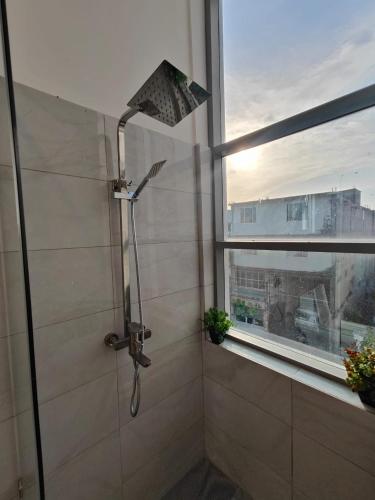 a shower in a bathroom with a window at The Kings Colombo in Colombo