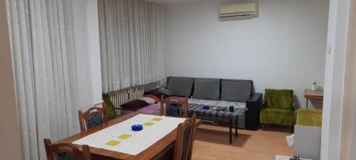 a living room with a couch and a table and chairs at Apartman Boba in Ruma