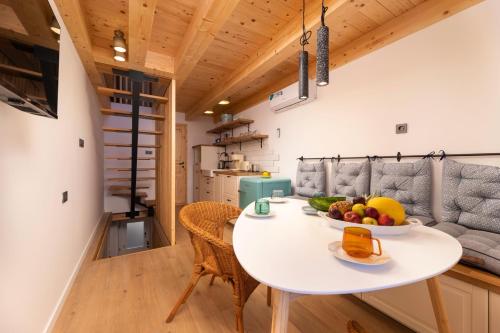 a kitchen and dining room with a white table at Little beach house in Baška
