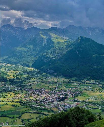 an aerial view of a town in a valley with mountains at Lejla's guesthouse in Gusinje