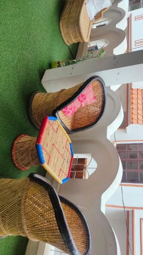 four pairs of shoes on the stairs of a building at Manavi Home Stay in Mathura