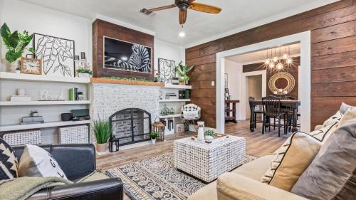 a living room with a couch and a fireplace at Curated Cottage. minutes from Silos, zoo, Baylor in Waco