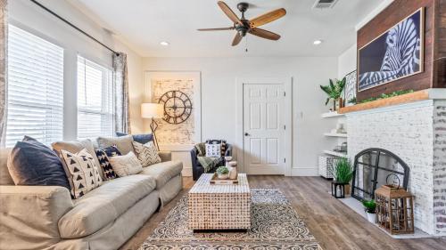 a living room with a couch and a fireplace at Curated Cottage. minutes from Silos, zoo, Baylor in Waco