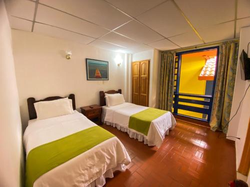 Postel nebo postele na pokoji v ubytování Ecohotel La Casona Pereira