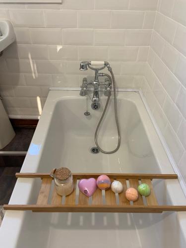 a bath tub with different types of donuts in it at Forest Hill View in Cinderford