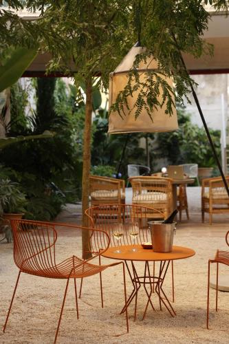 a table and chairs and a table with a lamp at Pátio do Tijolo in Lisbon