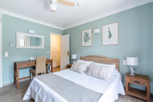 a bedroom with a bed and a desk and a desk at Chambres d'Hotes Les Amandiers in Saint-Tropez