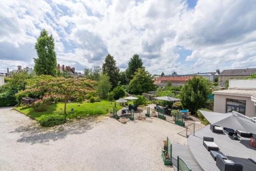an aerial view of a yard with a patio at Hotel des Ducs in Alençon