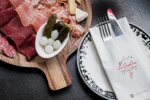 a plate of food with meat and vegetables on a table at Le Coucou Hotel Restaurant & Lounge-Bar in Montreux