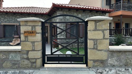 a black door with a sign in front of a building at Guesthouse Pyxari in Kalabaka