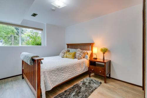 a bedroom with a bed and a window at Spacious Lake Forest Park Home with Deck! in Lake Forest Park