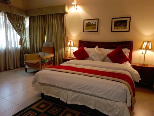 a hotel room with a large bed and a chair at Carlson Hotel, Osborne Foreshore Phase 2, Ikoyi in Lagos