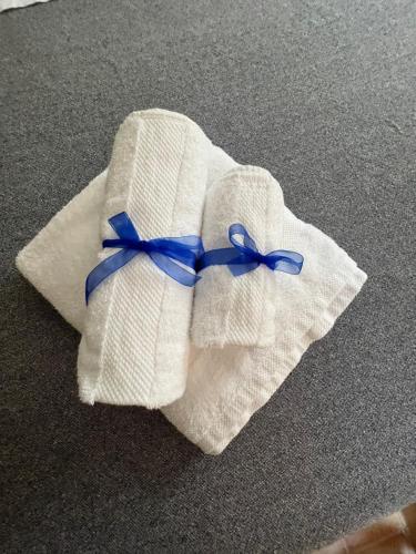 a white towel with a blue ribbon on it at Maison Sferisterio in Macerata