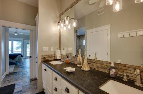 a bathroom with two sinks and a large mirror at Lake Livingston Paradise Outdoor Pool with Slide! in Coldspring