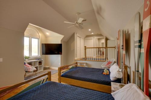 a bedroom with two beds and a tv at Lake Livingston Paradise Outdoor Pool with Slide! in Coldspring