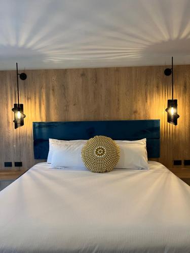 a bedroom with a white bed with a blue headboard at GUAJIRA CASA DEL MAR in Ríohacha
