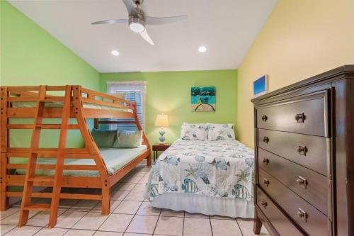 a bedroom with a bunk bed and a ladder at Sunbeam in Navarre