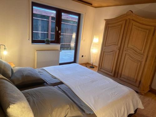 a large bed in a bedroom with a window at Ferienwohnung Elly 3 km zum Diemelradweg in Liebenau