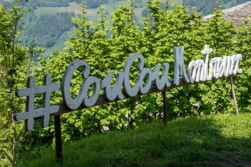a sign for the columbia sign in the grass at Le Coucou Hotel Restaurant & Lounge-Bar in Montreux