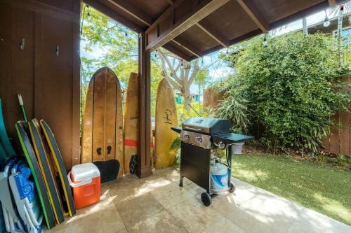 a barbecue grill in front of a group of surfboards at The Kumu House in Kailua-Kona